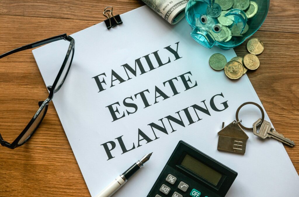Family estate planning document with glasses, pen, calculator, house key, and piggy bank filled with coins, emphasizing essential steps for effective estate management.